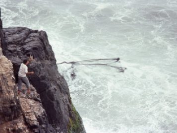 Casting a fishing net into the Pacific Ocean off Cerro Azul, Peru. Photo courtesy of Joyce Marcus. 
